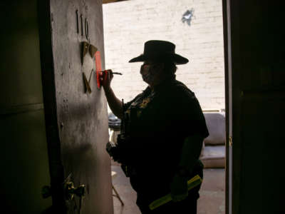 Maricopa County constable Darlene Martinez signs an eviction order on October 7, 2020 in Phoenix, Arizona.