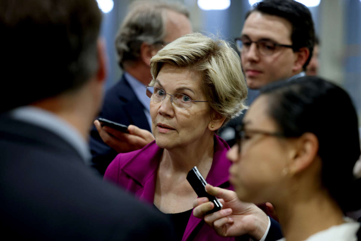 Sen. Elizabeth Warren speaks to reporters in the Senate subway during a procedural vote on June 22, 2021, in Washington, D.C.