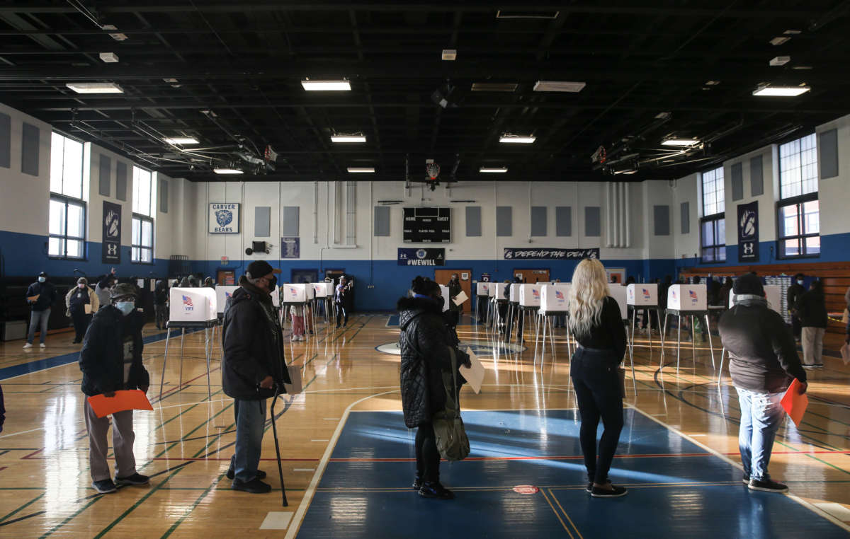 Residents of Baltimore City line up to cast their votes in the U.S. Presidential and local congressional elections at Carver Vocational Technical School on November 3, 2020, in Baltimore, Maryland.