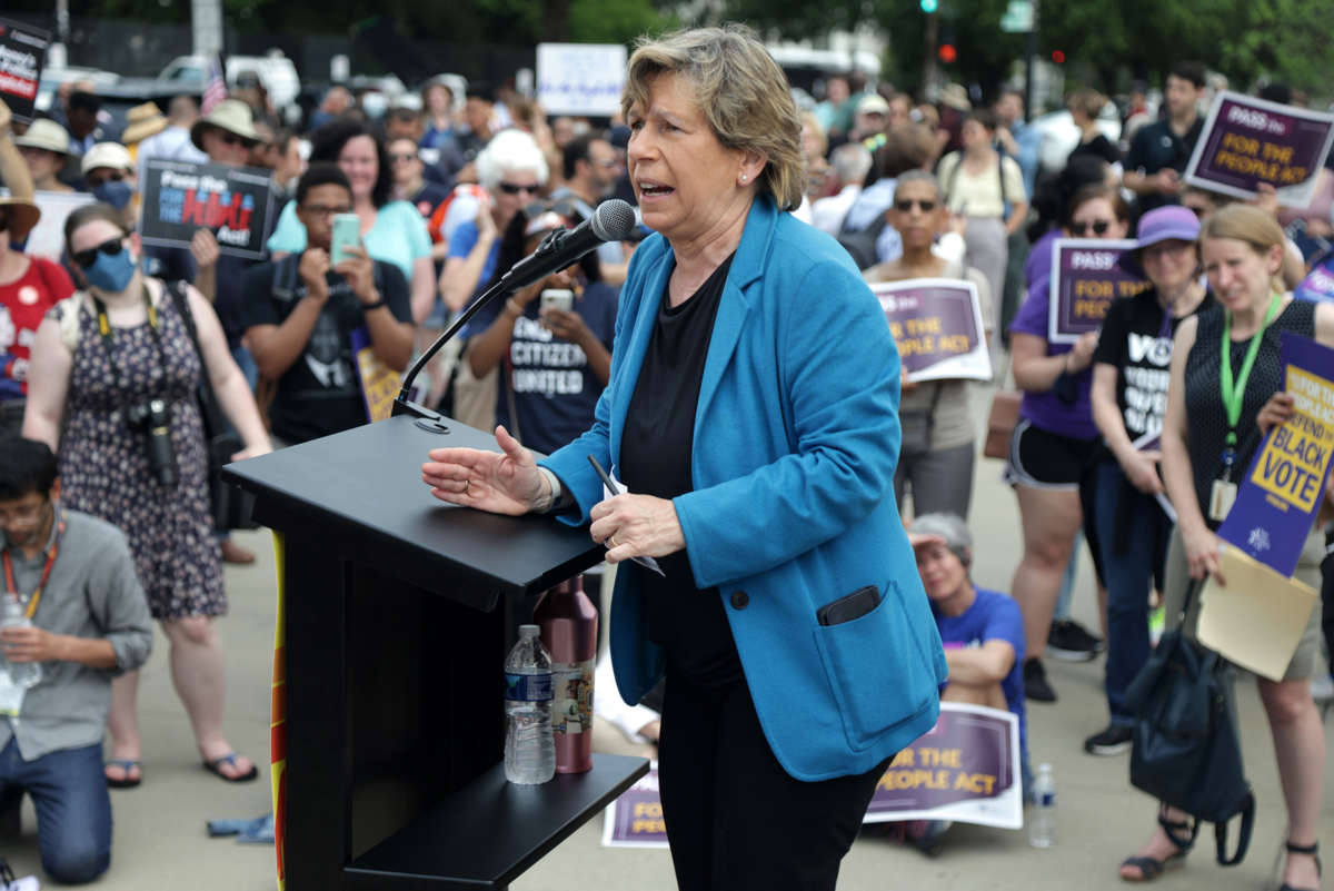 Randi Weingarten speaks to a crowd of protesters at a rally