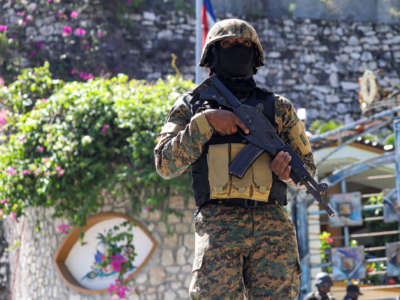 A Haitian police officer stands guard outside of the presidential residence on July 7, 2021, in Port-au-Prince, Haiti.