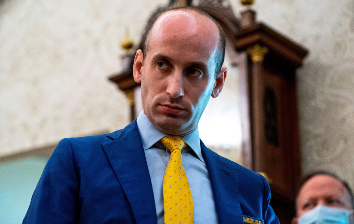 White House senio­r advis­er Steph­en Mille­r looks on as President Donald Trump addresses reporters in the Oval Office of the White House on July 15, 2020, in Washington D.C.