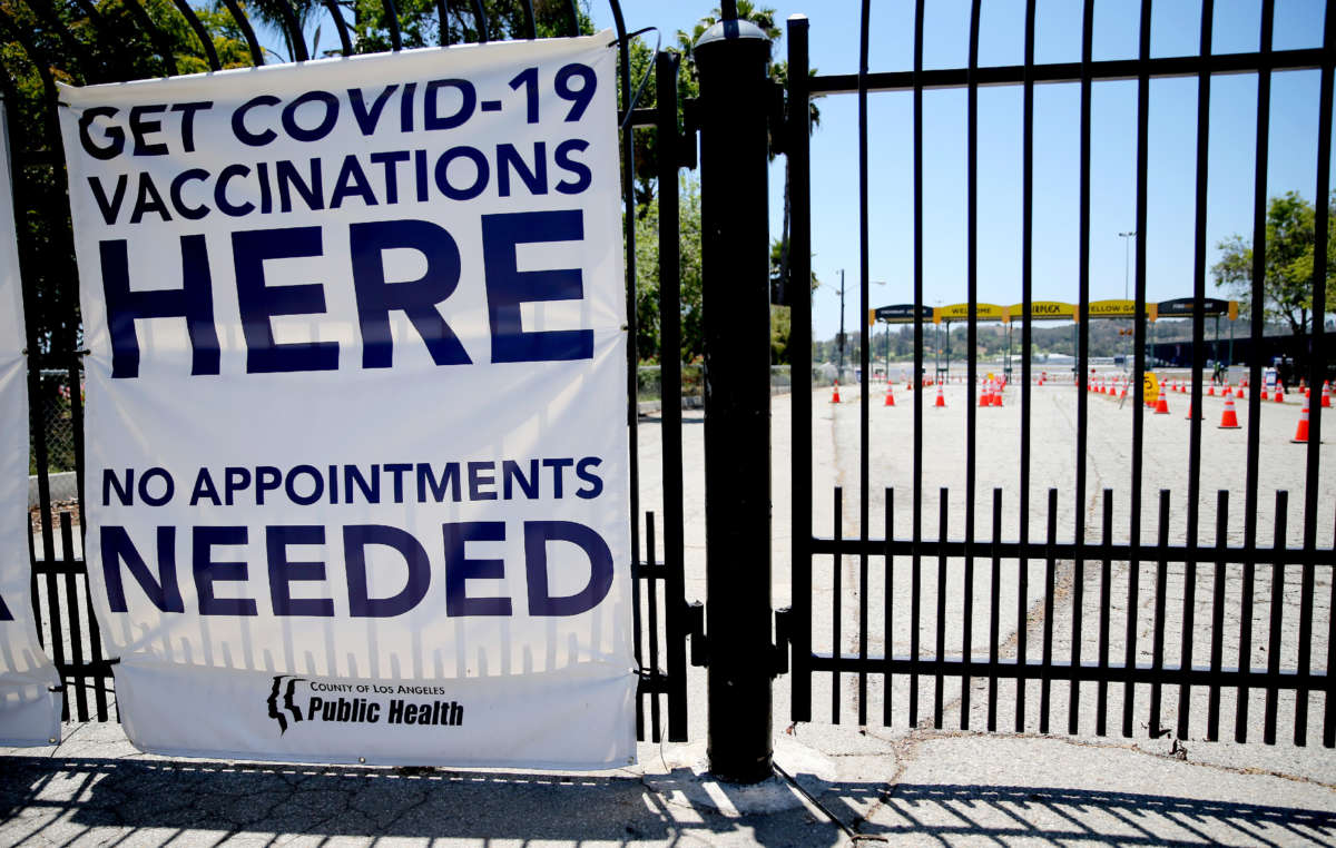 A sign promotes a nearly empty mass vaccination site at the Pomona Fairplex on June 10, 2021, in Pomona, California.