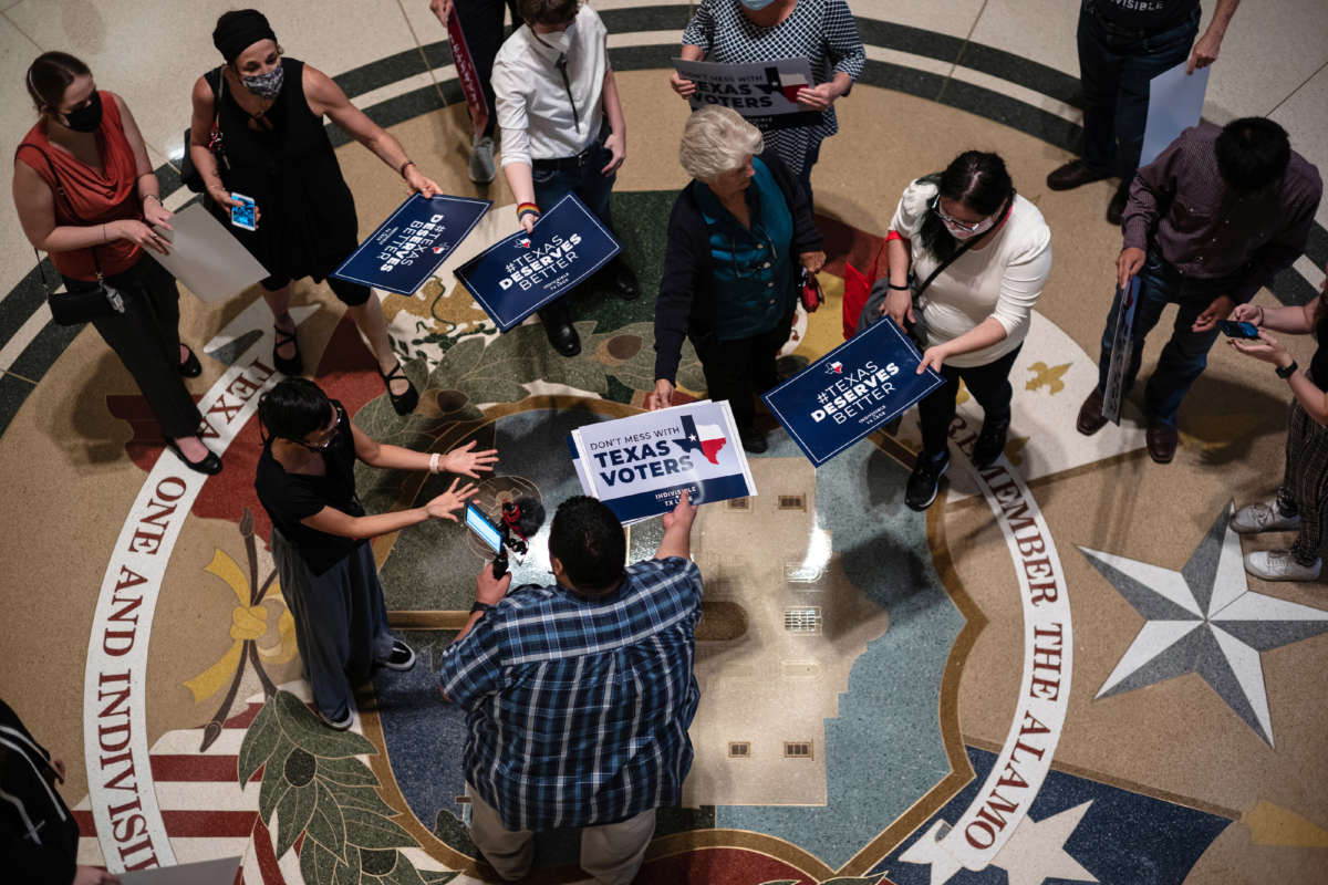 People opposed to the Texas Republican-led effort to pass new voting restrictions are gathered at the State Capitol as they wait to testify before state lawmakers who began committee hearings on election integrity bills on July 10, 2021, in Austin, Texas.