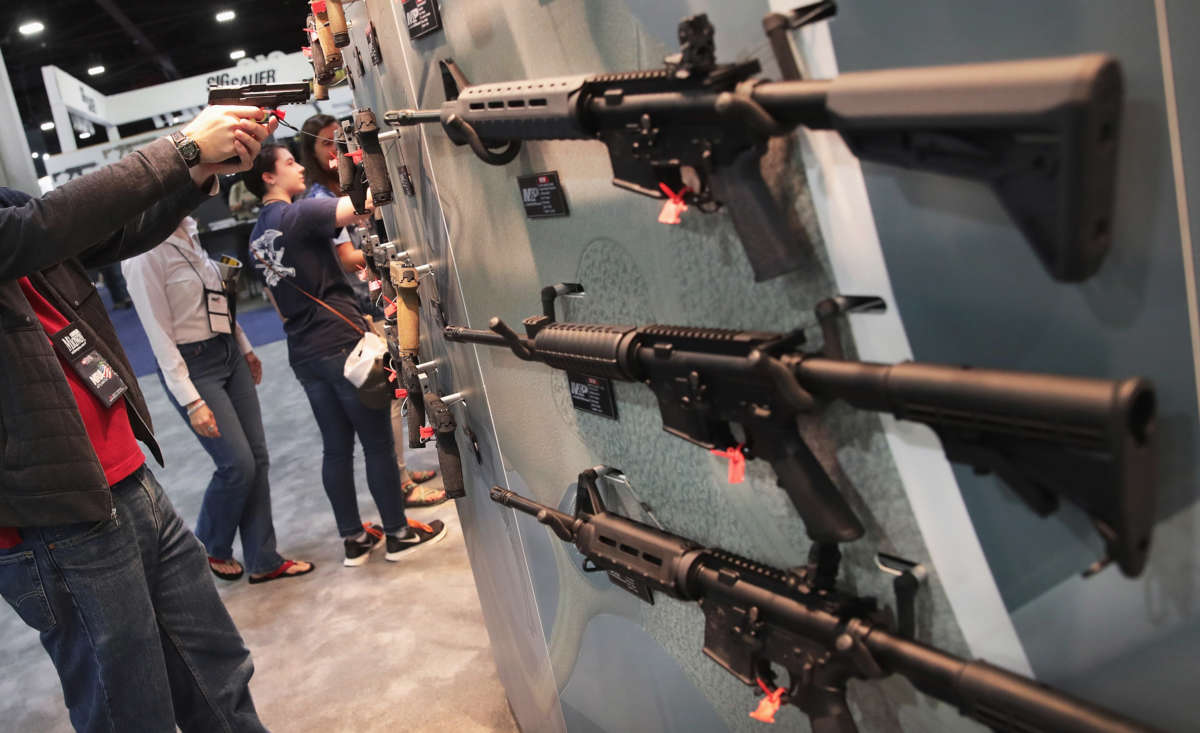 National Rifle Association members look over guns in the Smith & Wesson display at the 146th NRA Annual Meetings & Exhibits on April 29, 2017, in Atlanta, Georgia.