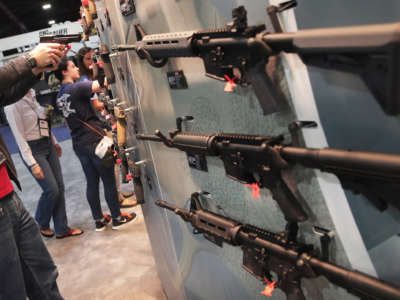 National Rifle Association members look over guns in the Smith & Wesson display at the 146th NRA Annual Meetings & Exhibits on April 29, 2017, in Atlanta, Georgia.