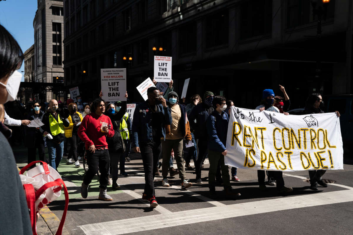Demonstrators march in Downtown Chicago, Illinois, during a protest in support of Illinois lifting the ban on rent control on March 20, 2021.