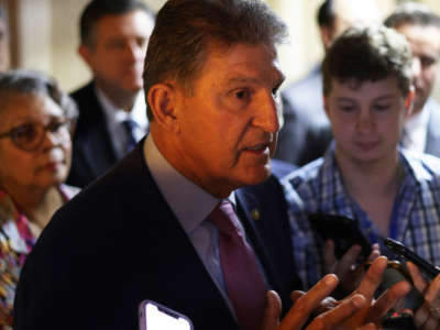 Sen. Joe Manchin talks to reporters as he leaves after a meeting with members of Texas House Democratic Caucus at the U.S. Capitol on July 15, 2021, in Washington, D.C.