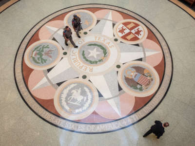 People walk through the rotunda of the Texas State Capitol on the first day of the 87th Legislative Special Session on July 8, 2021, in Austin, Texas.