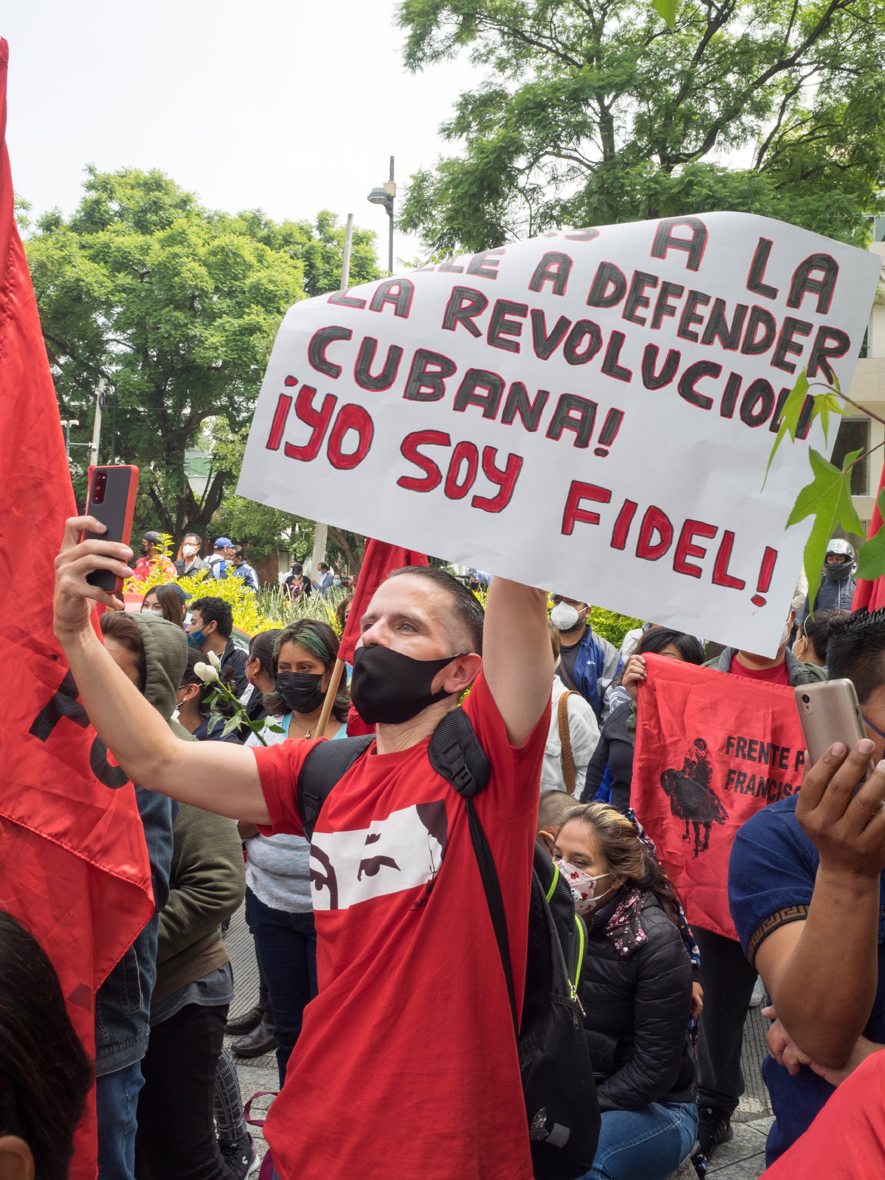 A demonstrator holds up a sign that reads "I am Fidel" during a demonstration in solidarity with the Cuban Revolution in front of the Cuban embassy in Mexico City, Mexico, July 17, 2021.
