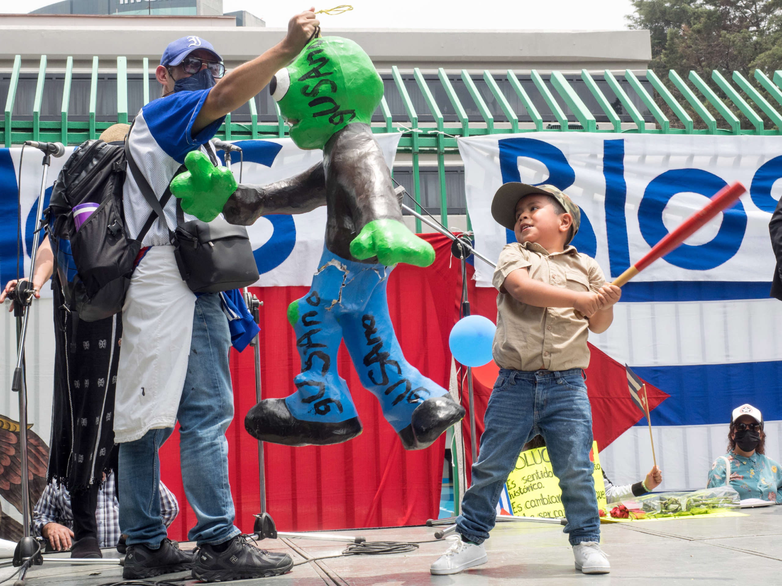 A young boy strikes a piñata emblazoned with the term “gusano” that is used by supporters of the Cuban Revolution to refer to counterrevolutionaries, Mexico City, Mexico, on July 17, 2021.