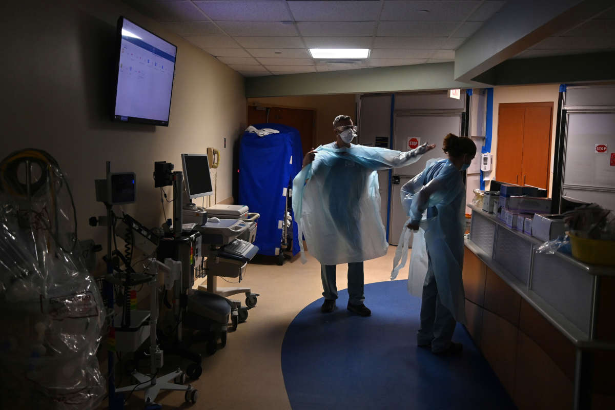 Hospital staff suit up with PPE in the COVID-19 section before entering the ward to work with patients in Tampa, Florida, on August 19, 2020.