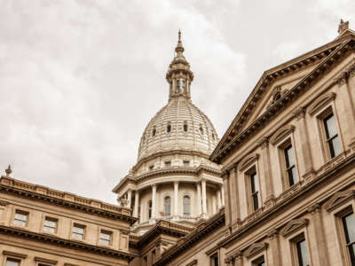 Daylight view from below of Michigan State capitol building on overcast day in Lansing, Michigan.