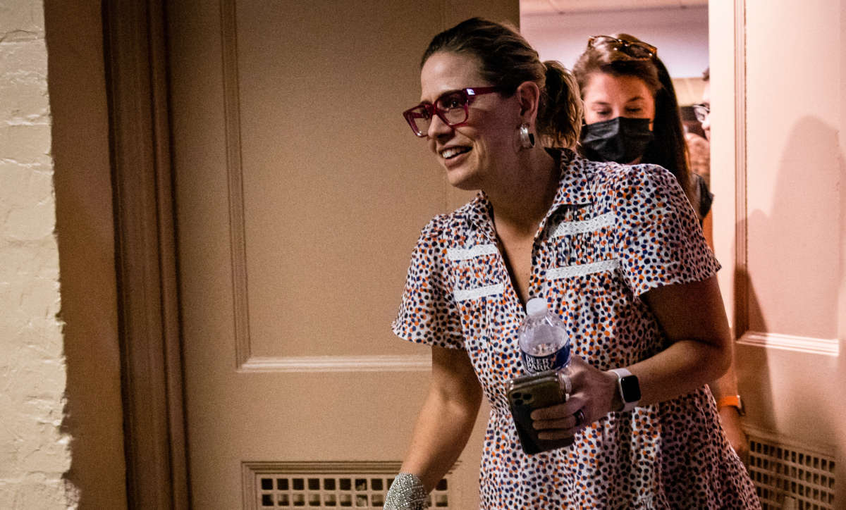 Sen. Kyrsten Sinema leaves a meeting between a group of bipartisan Senators in the basement of the U.S. Capitol Building on July 26, 2021, in Washington, D.C.