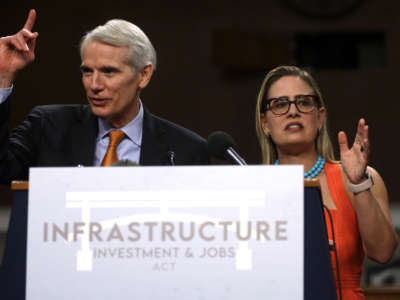 Senators Rob Portman and Kyrsten Sinema answer questions from members of the press during a news conference after a procedural vote for the bipartisan infrastructure framework at Dirksen Senate Office Building on July 28, 2021, on Capitol Hill in Washington, D.C.