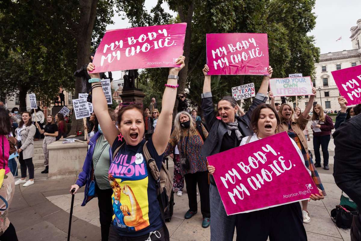 Protesters display signs reading "MY BODY, MY CHOICE" during an outdoor demonstration