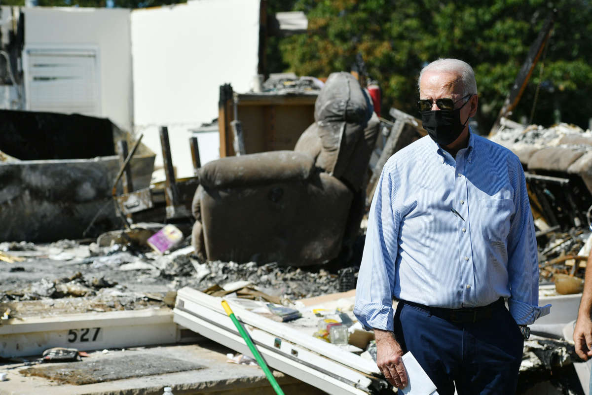 President Joseph Robinette Biden gazes over wreckage