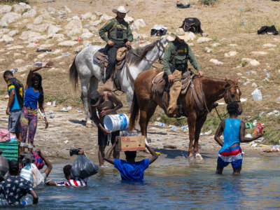 White men on horses harass people exercising their human rights