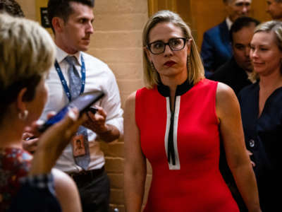 Sen. Kyrsten Sinema heads back to a bipartisan meeting on infrastructure in the basement of the U.S. Capitol building on June 8, 2021, in Washington, D.C.