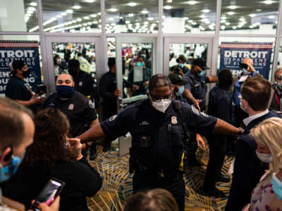 Election challengers demand to enter to observe the absentee ballots counting but were dined after the room reached capacity during the 2020 general election in Detroit, Michigan, on November 4, 2020.