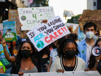 Hundreds protest to raise awareness of climate change while marching down to the Battery Park of Manhattan in New York City on September 24, 2021.