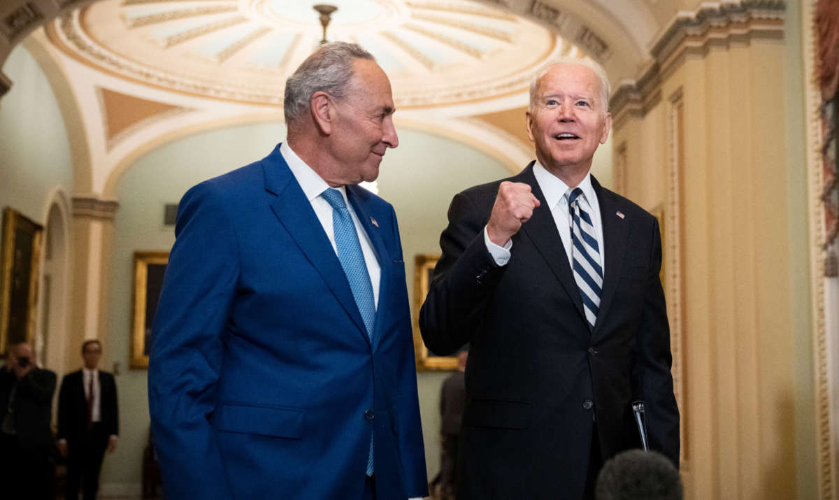 Senate Majority Leader Chuck Schumer and President Joe Biden speak briefly to reporters as they arrive at the U.S. Capitol for a Senate Democratic luncheon on July 14, 2021, in Washington, D.C.