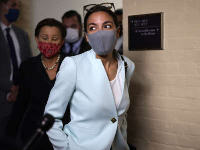 Rep. Alexandria Ocasio-Cortez leaves after a House Democratic Caucus meeting with President Joe Biden at the U.S. Capitol on October 1, 2021, in Washington, D.C.