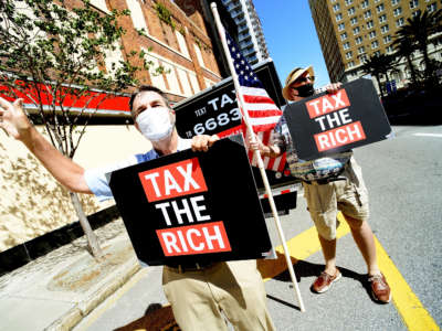 John Stewart, left, and Jay Alexander of MoveOn call on Senator Marco Rubio's office to increase federal taxes to big corporations on May 17, 2021, in Tampa, Florida.