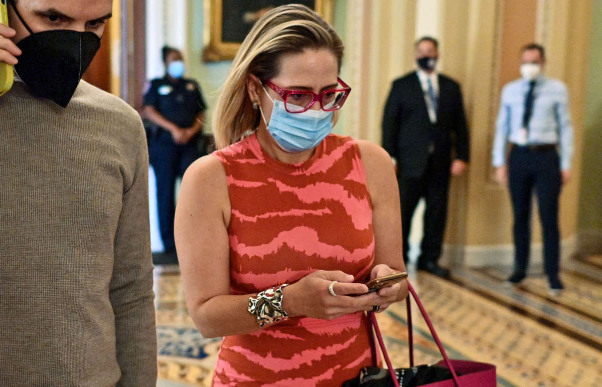 Sen. Kyrsten Sinema walks through the Senate at the U.S. Capitol in Washington, D.C., on September 30, 2021.