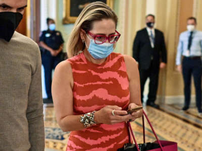 Sen. Kyrsten Sinema walks through the Senate at the U.S. Capitol in Washington, D.C., on September 30, 2021.