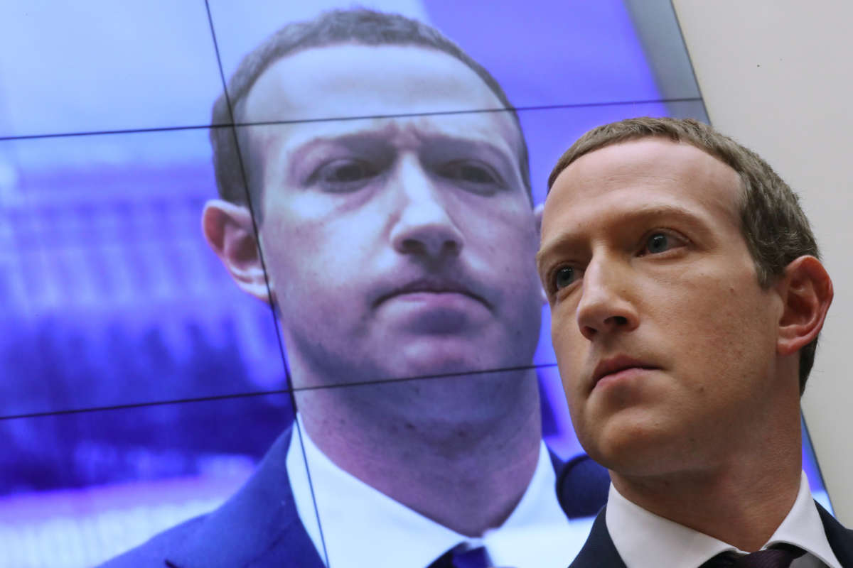 With an image of himself on a screen in the background, Facebook co-founder and CEO Mark Zuckerberg testifies before the House Financial Services Committee in the Rayburn House Office Building on Capitol Hill on October 23, 2019, in Washington, D.C.