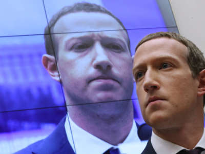 With an image of himself on a screen in the background, Facebook co-founder and CEO Mark Zuckerberg testifies before the House Financial Services Committee in the Rayburn House Office Building on Capitol Hill on October 23, 2019, in Washington, D.C.