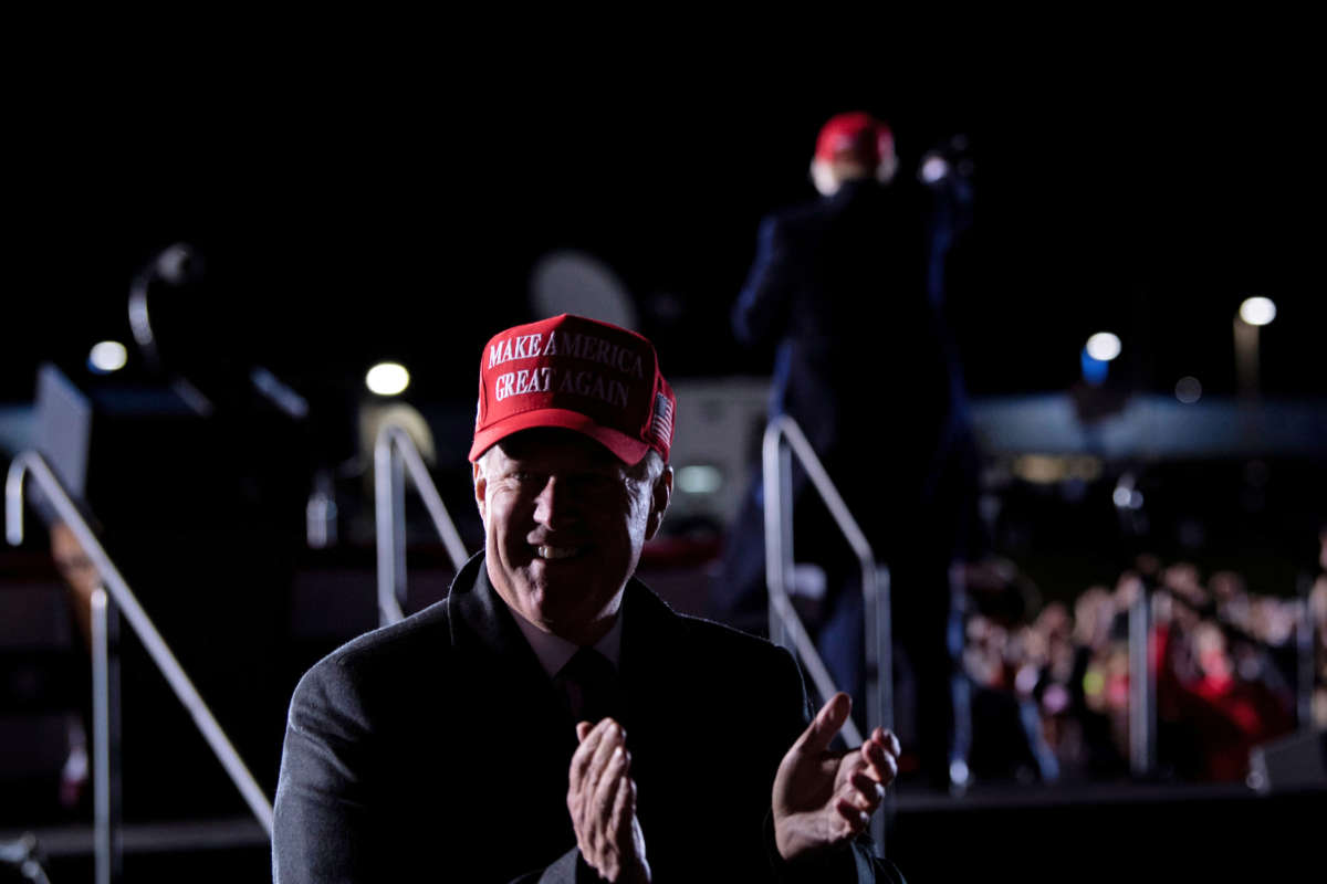 White House Chief of Staff Mark Meadows claps as President Donald Trump leaves after speaking during a rally at Hickory Regional Airport in Hickory, North Carolina, on November 1, 2020.