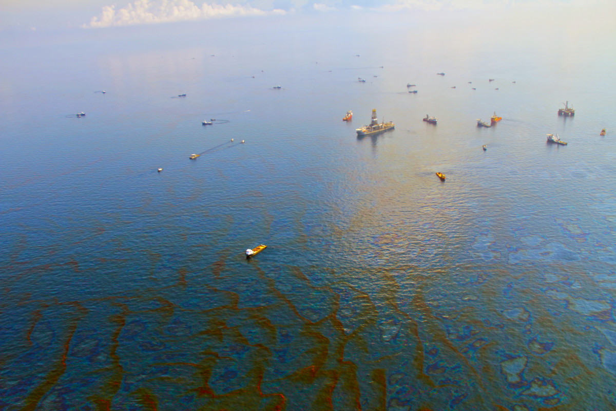 Cleanup crew vessels stand in oil-slicked water 30 days after the Deepwater Horizon disaster in the Gulf Of Mexico on June 9, 2010.