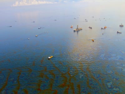Cleanup crew vessels stand in oil-slicked water 30 days after the Deepwater Horizon disaster in the Gulf Of Mexico on June 9, 2010.