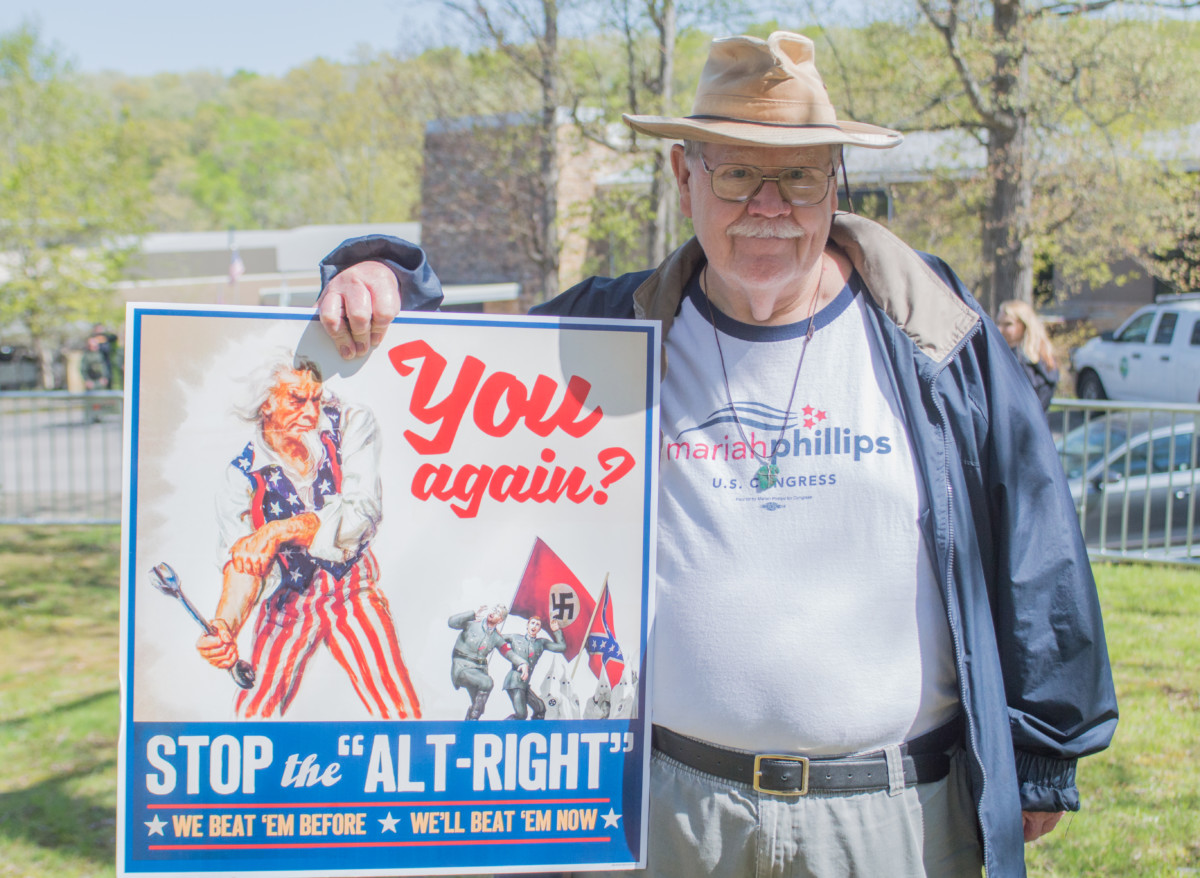 Tennessee resident and Navy veteran Paul Adams holds a sign during a protest of the 2018 American Renaissance conference in Burns, Tennessee.