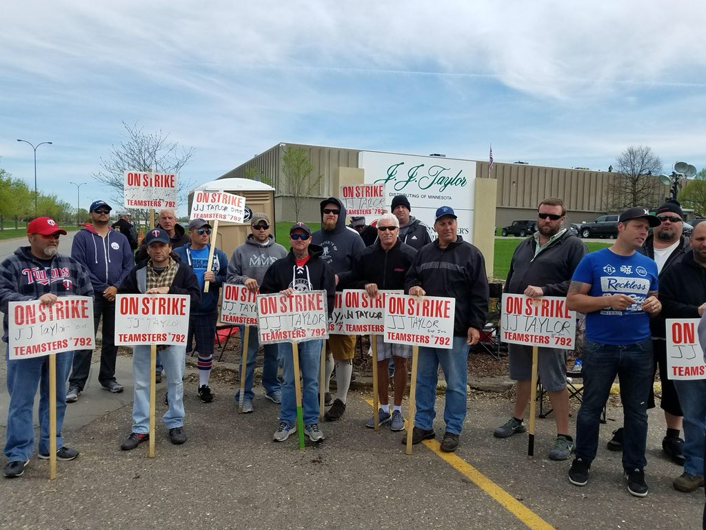 Delivery drivers and warehouse workers strike outside the J.J. Taylor Distribution Company of Minnesota on May 10, 2018.