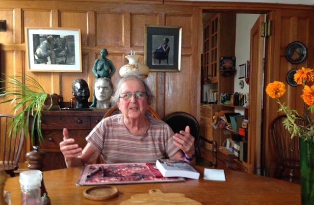 A woman sits at her table