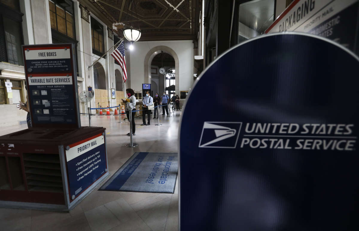 People wait for service at a post office in New York City on August 19, 2020.