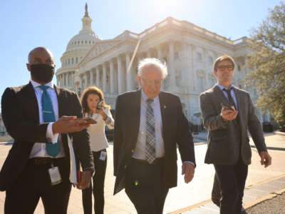 Senate Budget Committee Chairman Bernie Sanders is pursued by reporters as he leaves the U.S. Capitol following votes on September 29, 2021, in Washington, DC.