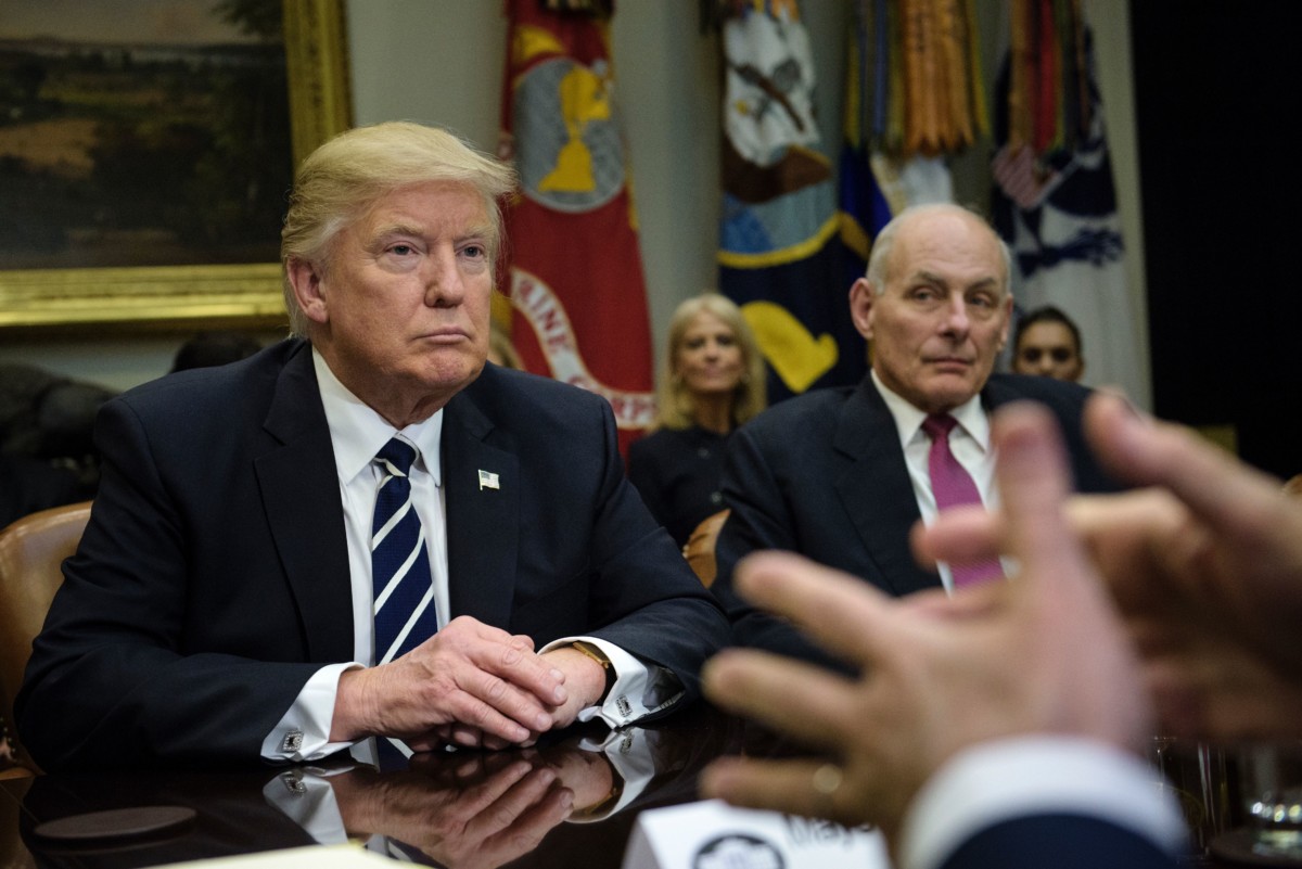 President Donald Trump and Secretary of Homeland Security John Kelly (R) listen while Rudy Giuliani speaks at a meeting on cyber security in the Roosevelt Room of the White House, January 31, 2017, in Washington, DC.