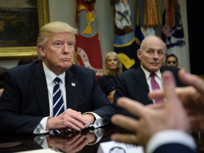 President Donald Trump and Secretary of Homeland Security John Kelly (R) listen while Rudy Giuliani speaks at a meeting on cyber security in the Roosevelt Room of the White House, January 31, 2017, in Washington, DC.
