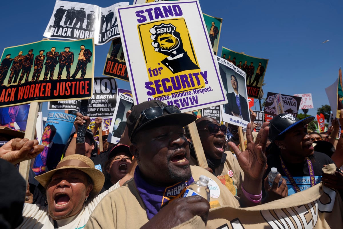 People march during a rally marking the international workers May Day in in Los Angeles, California on May 1, 2017. Activists marked the International Workers' Day with rallies in support of rights for workers and immigrants, as well as opposition to President Donald Trump's policies.