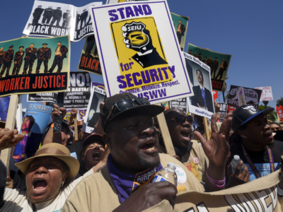 People march during a rally marking the international workers May Day in in Los Angeles, California on May 1, 2017. Activists marked the International Workers' Day with rallies in support of rights for workers and immigrants, as well as opposition to President Donald Trump's policies.