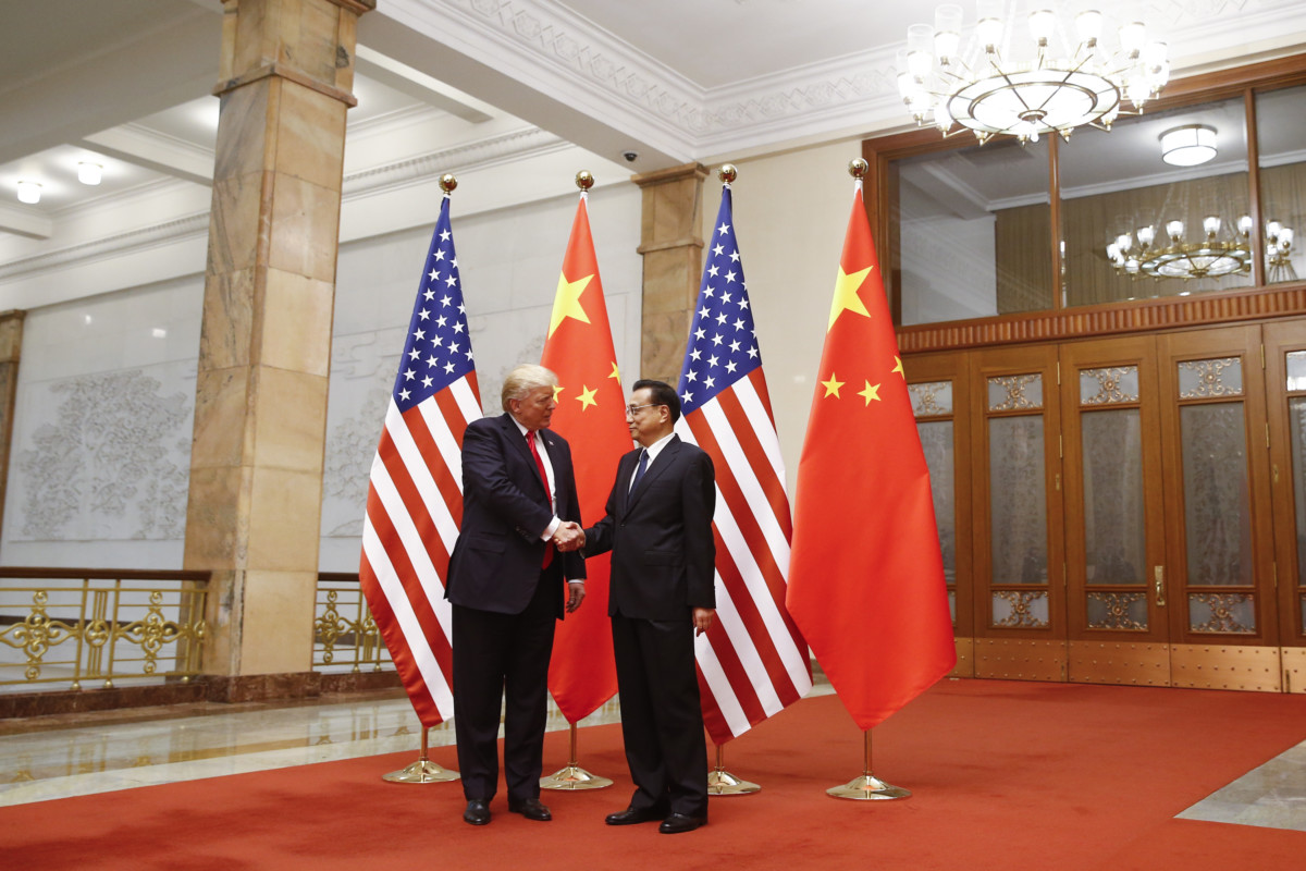 US President Donald Trump shakes hands with Chinese Premier Li Keqiang during a meeting at the Great Hall of the People in Beijing on November 9, 2017.