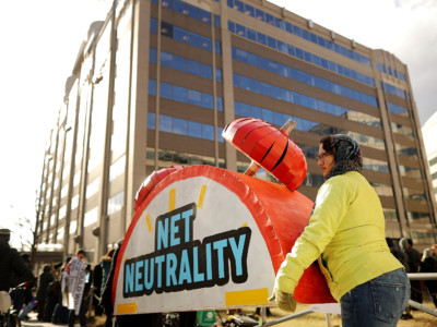 Rally organizers carry away props following a protest outside the Federal Communications Commission (FCC) building against the end of net neutrality rules December 14, 2017, in Washington, DC. Led by FCC Chairman Ajit Pai, the commission this week announced net neutrality will end on June 11, 2018.