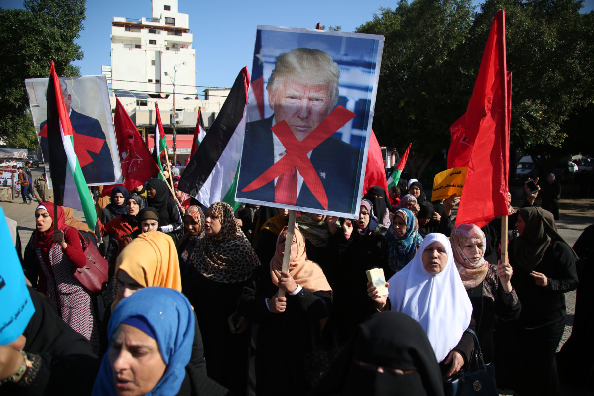 Palestinian women hold banners during a protest against US President Donald Trump's decision to recognize Jerusalem as the capital of Israel, in Gaza City on December 17, 2017.