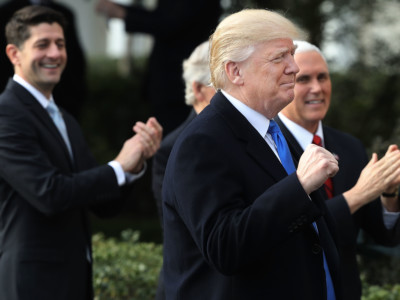 President Donald Trump pumps his fist during an event to celebrate Congress passing the Tax Cuts and Jobs Act with Republican members of the House and Senate on the South Lawn of the White House December 20, 2017, in Washington, DC.