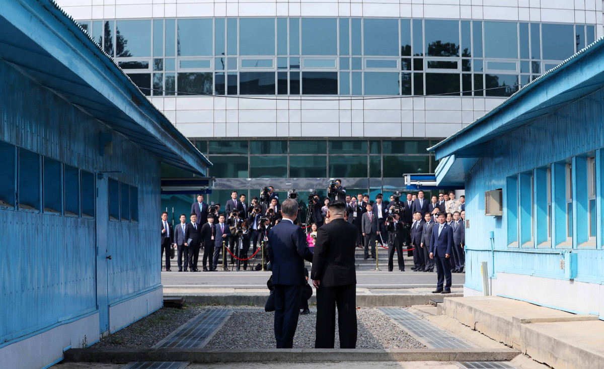 North Korean Leader Kim Jong Un and South Korean President Moon Jae-in shake hands over the military demarcation line upon meeting for the Inter-Korean Summit on April 27, 2018, in Panmunjom, South Korea.