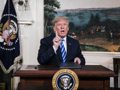 President Donald J. Trump signs a National Security Presidential Memorandum as he announces the withdrawal of the United States from the Iran nuclear deal during a "Joint Comprehensive Plan of Action" event in the Diplomatic Reception Room of the White House on Tuesday, May 8, 2018, in Washington, DC.